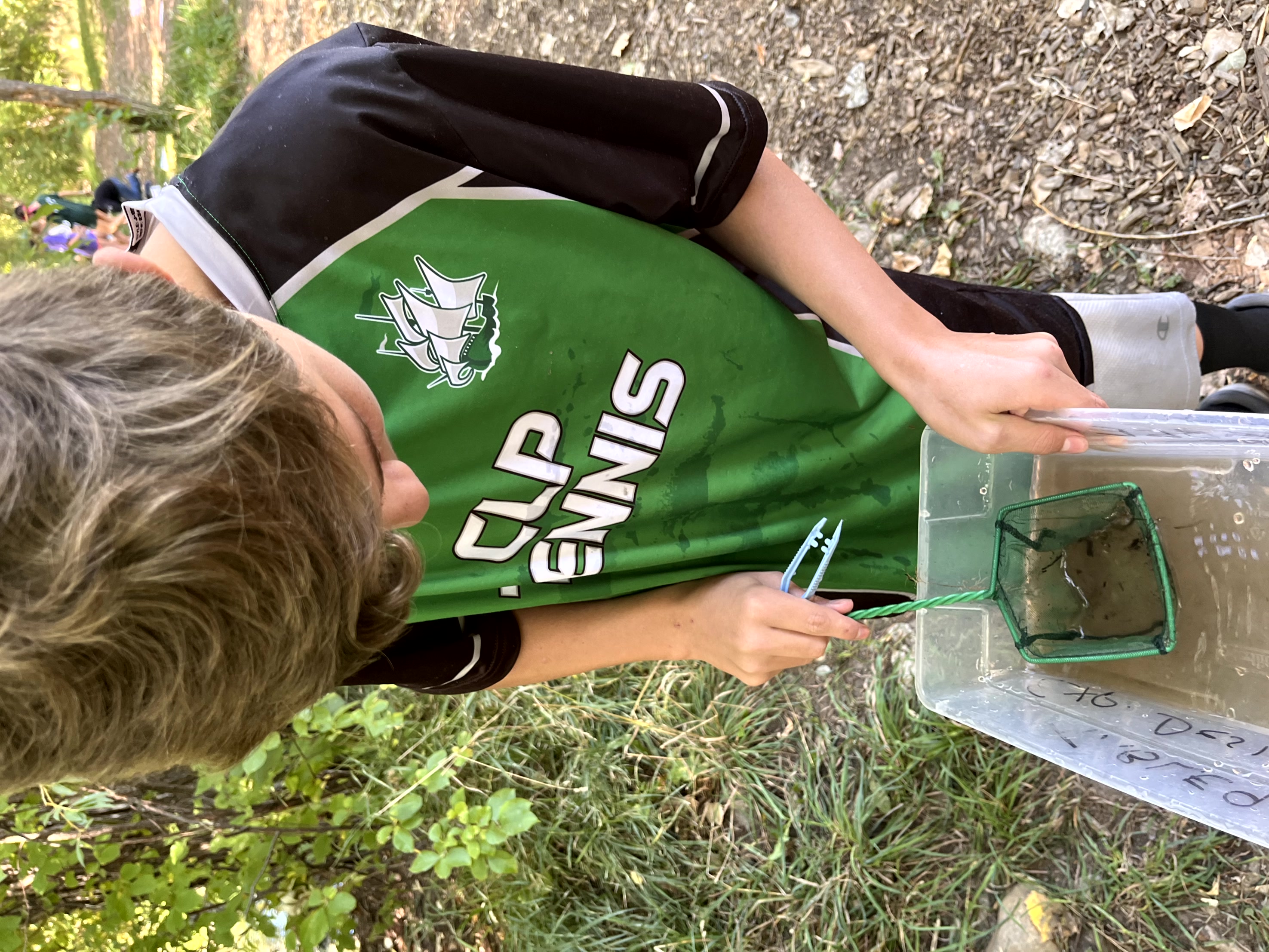 Student using a net to investigate