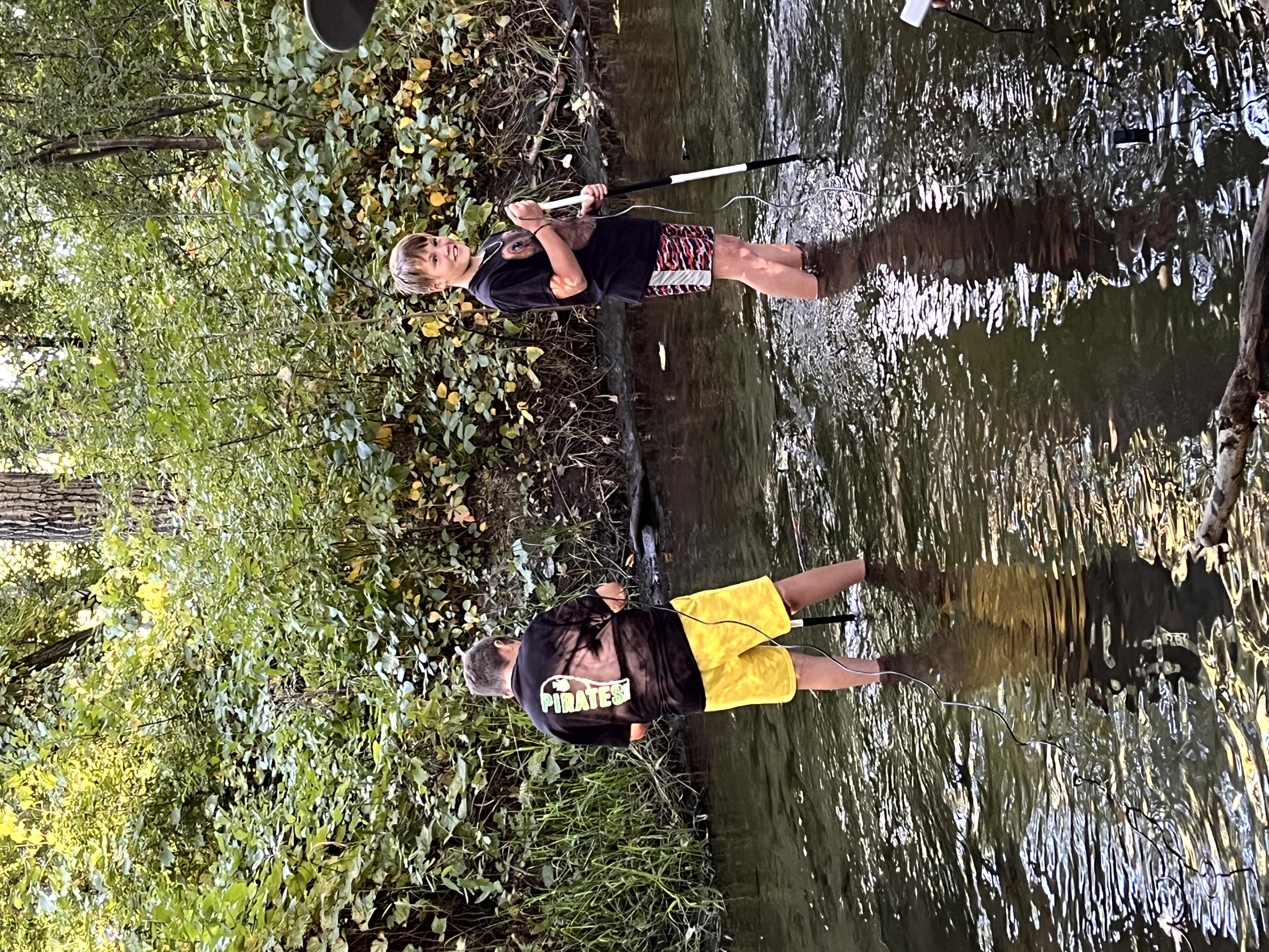 2 boys in the River with science tools